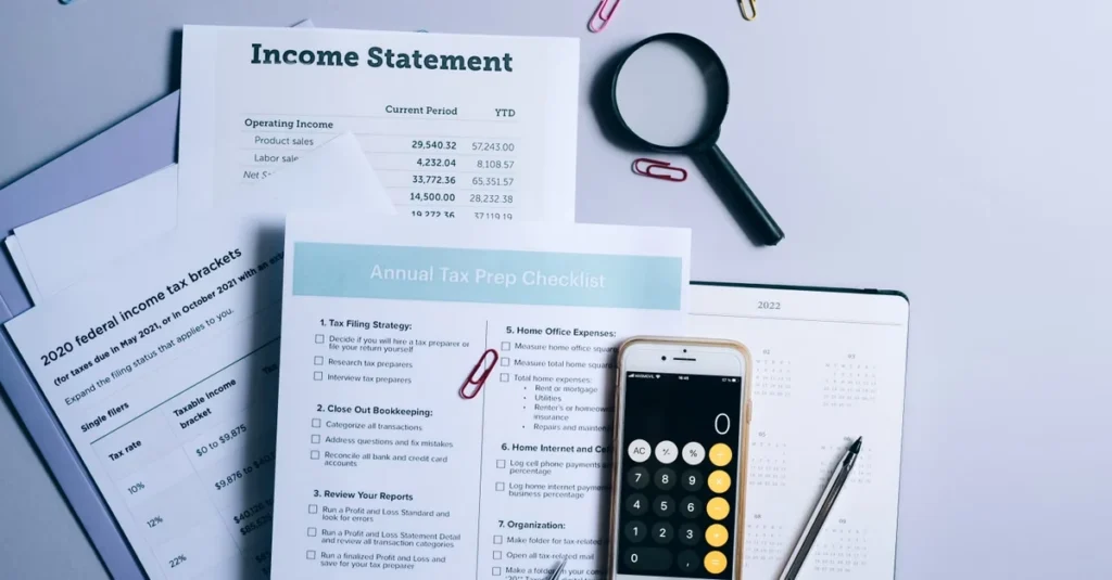 Income statement document with calculator, magnifying glass, and annual tax preparation checklist for CPA vs CFO comparison.
